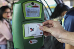 Cartão usuário sendo autorizado a passar a catraca, em tubo de ôniubus.