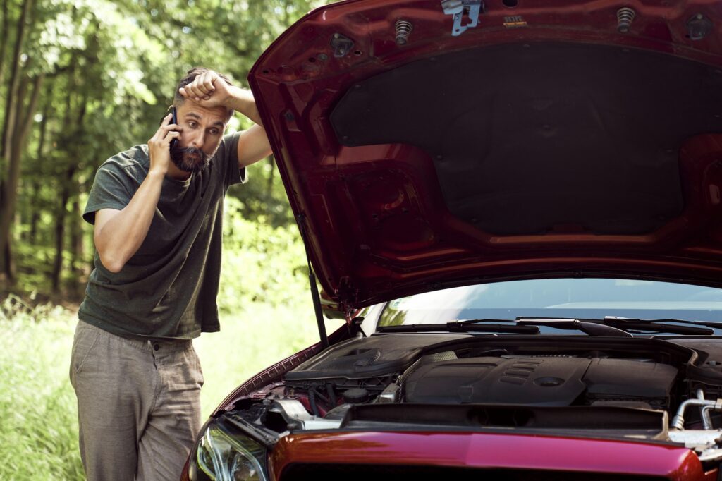 Man with a car problem using the phone for help